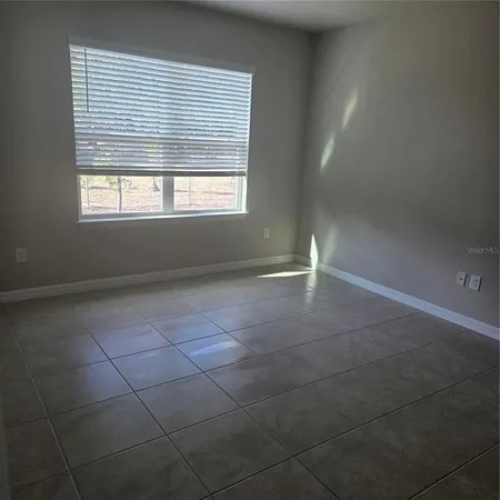 a bathroom with a granite countertop shower a sink and a mirror