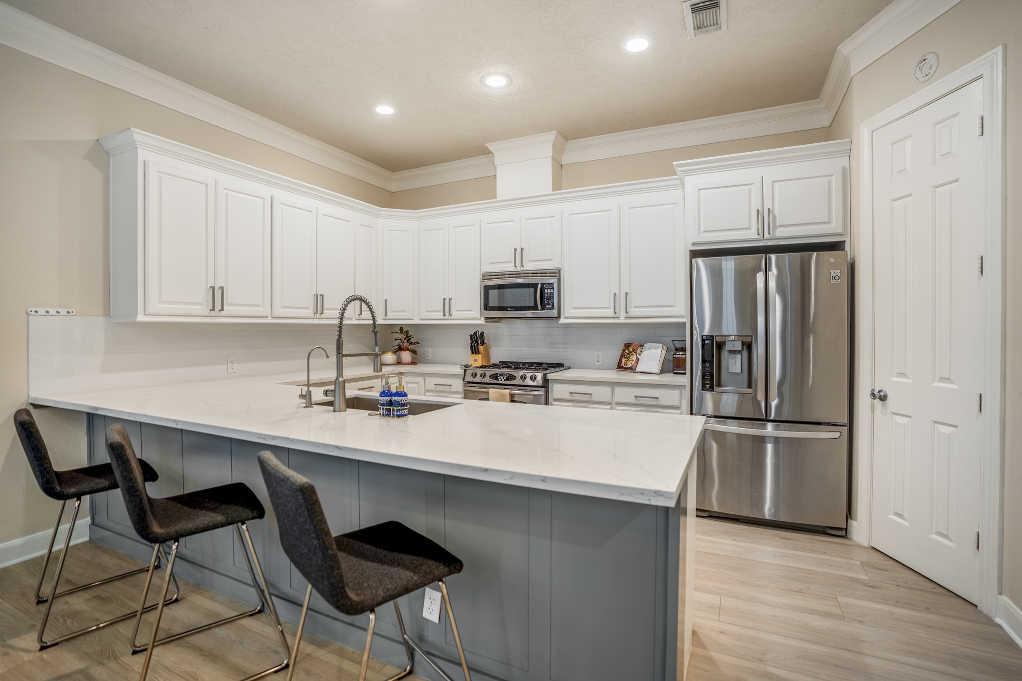 4236 Drake Street Houston, TX 77005 - Photo 6 of 43 Quartz countertops in the remodeled Kitchen provide a durable yet stylish surface for everyday living and entertaining, while a spacious walk-in pantry provides plenty of storage for necessities and more.