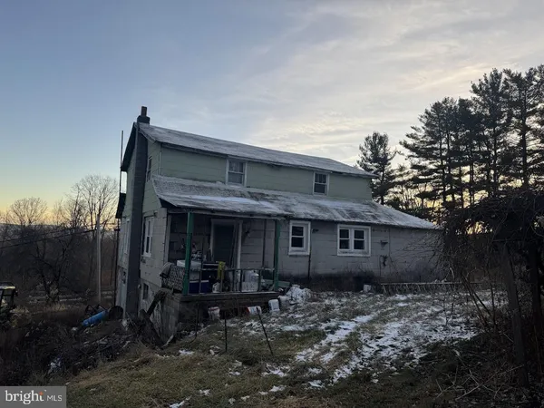 a view of house with yard and outdoor seating
