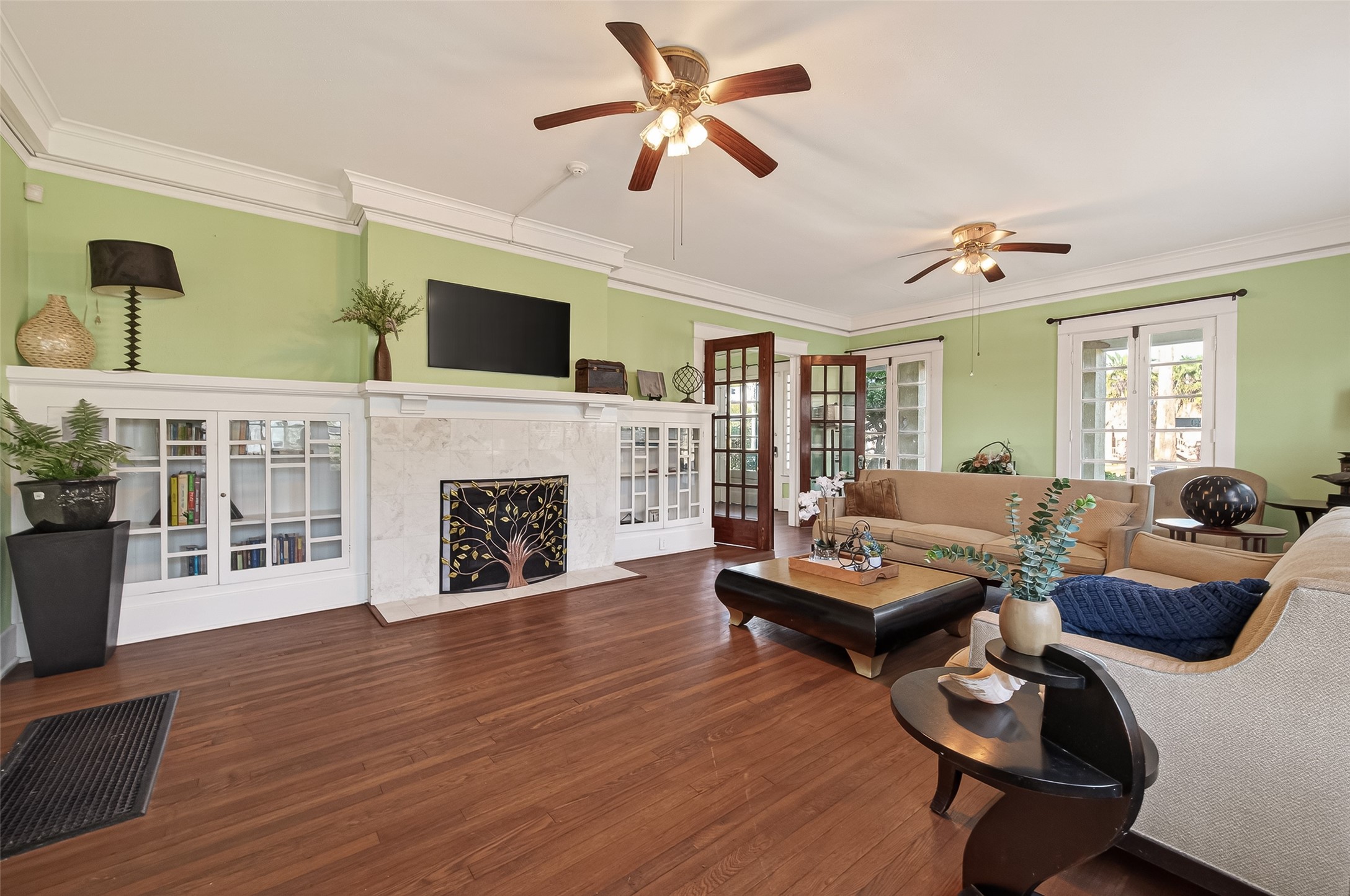 1723 Rosenberg Street Galveston, TX 77550 - Photo 11 of 38 Spacious living room with fireplace and windows overlooking the yard.