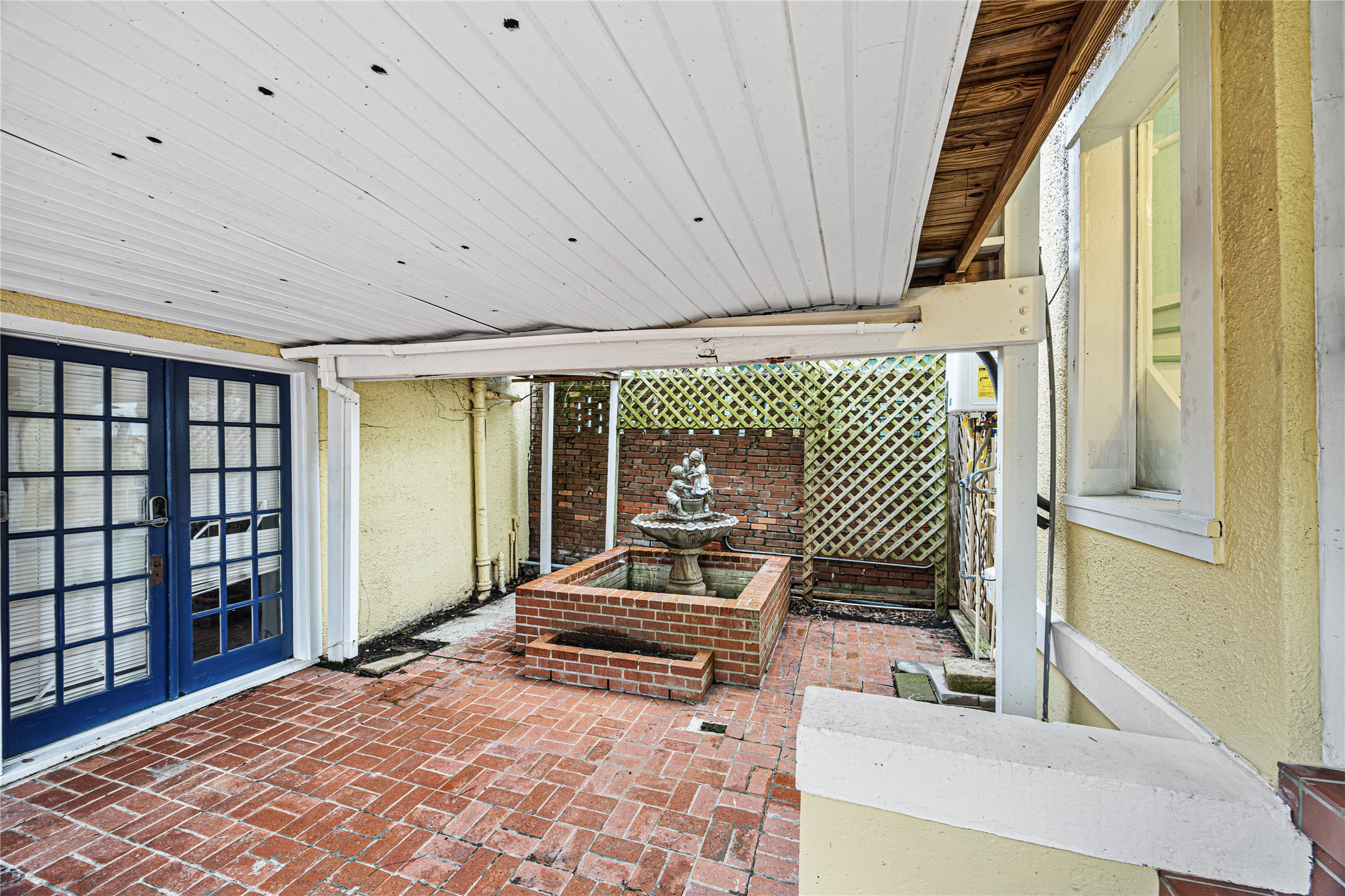 1723 Rosenberg Street Galveston, TX 77550 - Photo 34 of 38 Covered area leading to detached garage. Featuring historic water fountain.