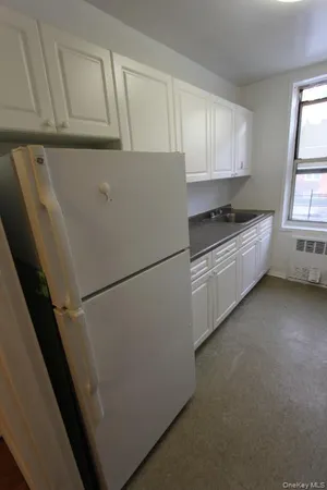 a kitchen with cabinets and white stainless steel appliances