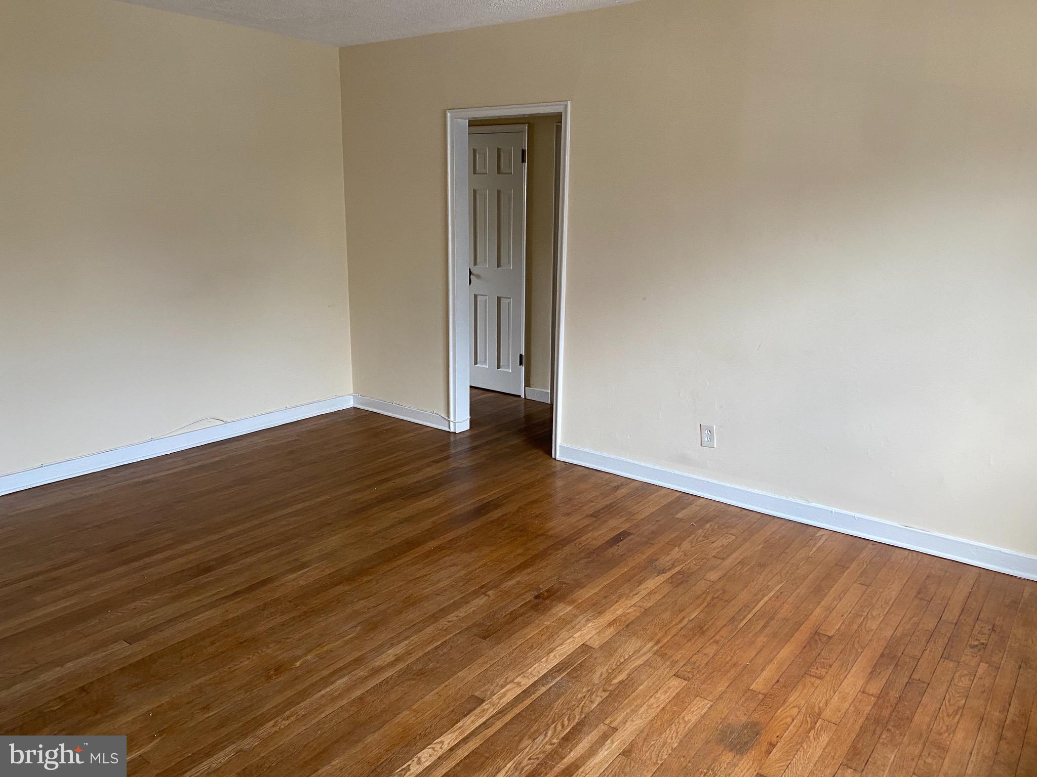 203 East Glebe Road, Unit D Alexandria, VA 22305 - Photo 2 of 12 a view of an empty room with wooden floor and a window