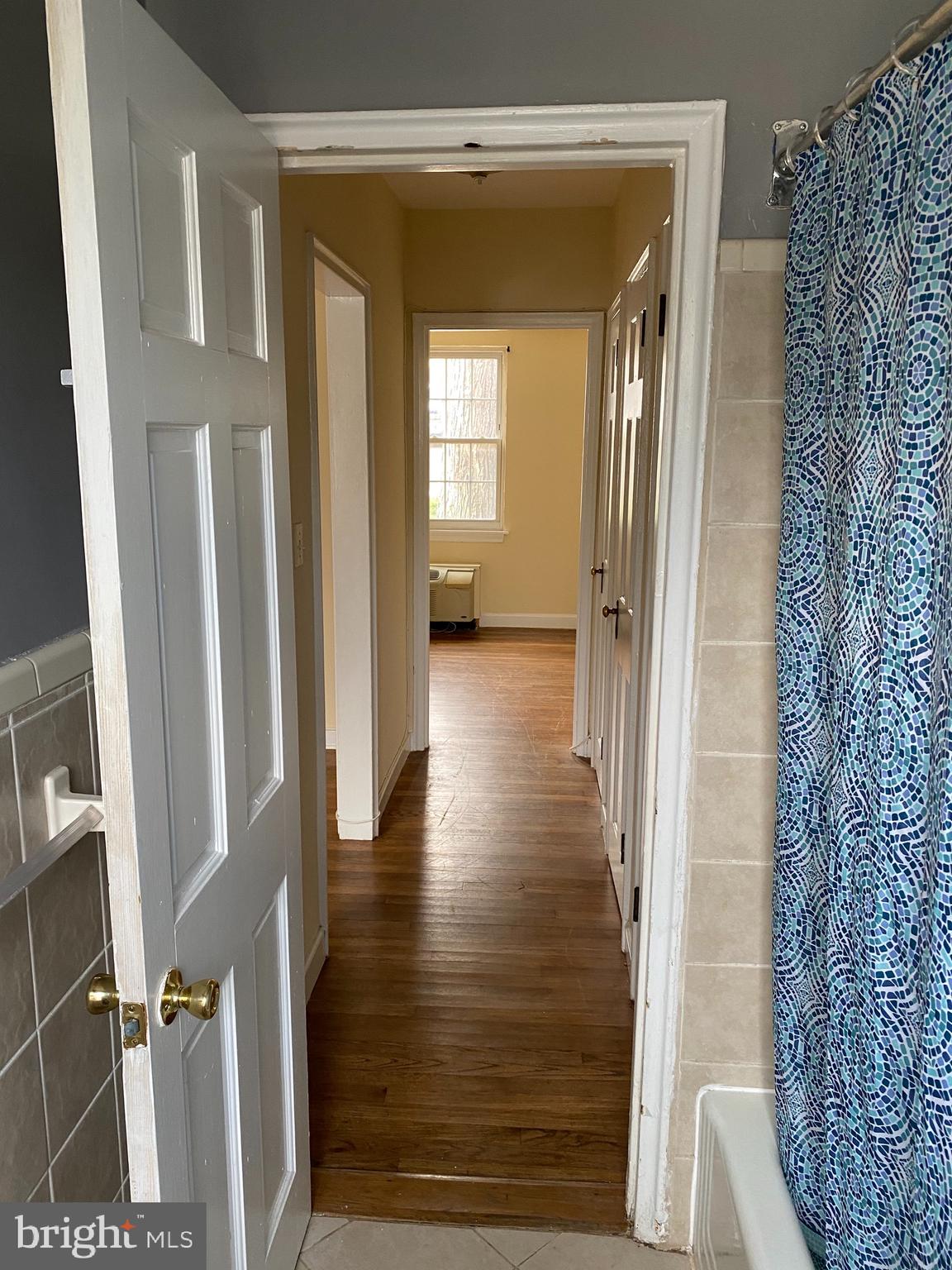 203 East Glebe Road, Unit D Alexandria, VA 22305 - Photo 9 of 12 a view of a hallway with wooden floor and staircase
