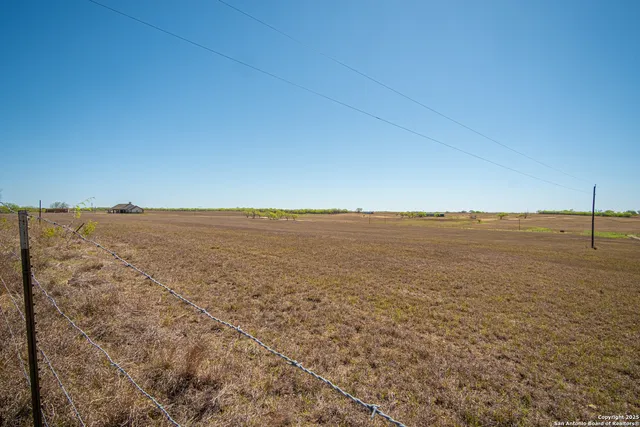 a view of a swimming pool with lawn chairs under an umbrella