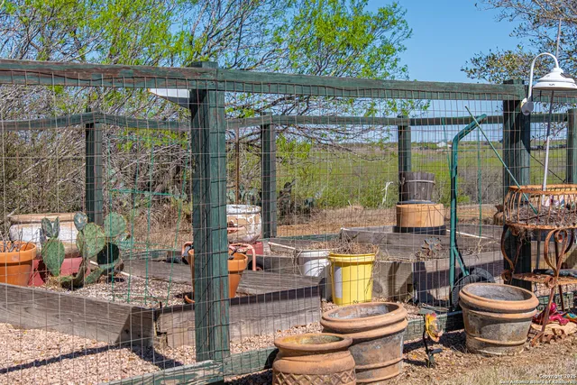a backyard of a house with lots of green space and fountain