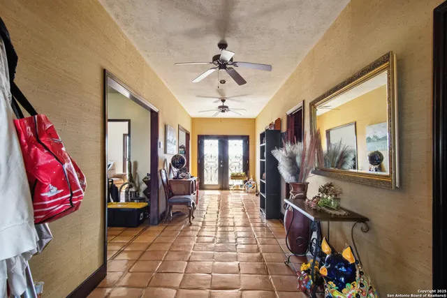 a view of a very nice looking living room with a chandelier furniture and windows