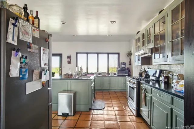 a kitchen with lots of counter top space and furniture