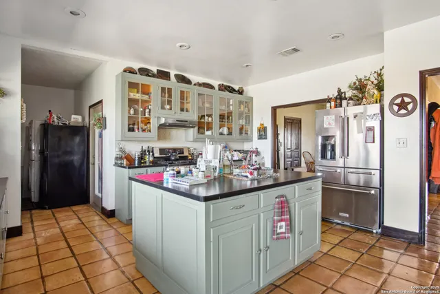 a kitchen with refrigerator and cabinets