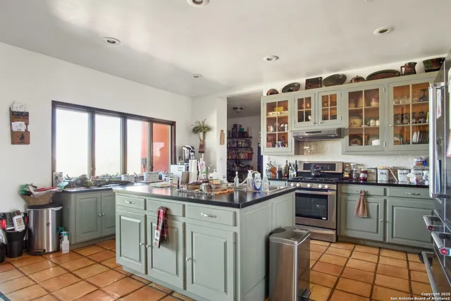 a kitchen with stainless steel appliances a sink stove and cabinets
