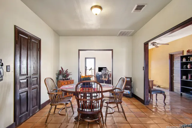 a view of a dining room with furniture and window