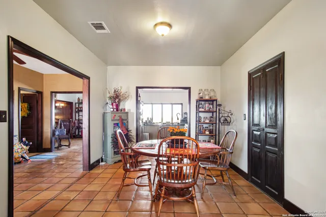 a dining room with furniture and window
