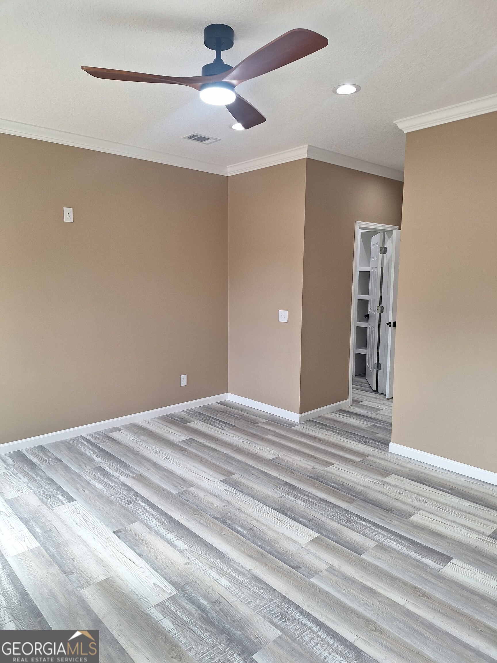 155 Peach Lane Baxley, GA 31513 - Photo 16 of 19 a view of empty room with wooden floor