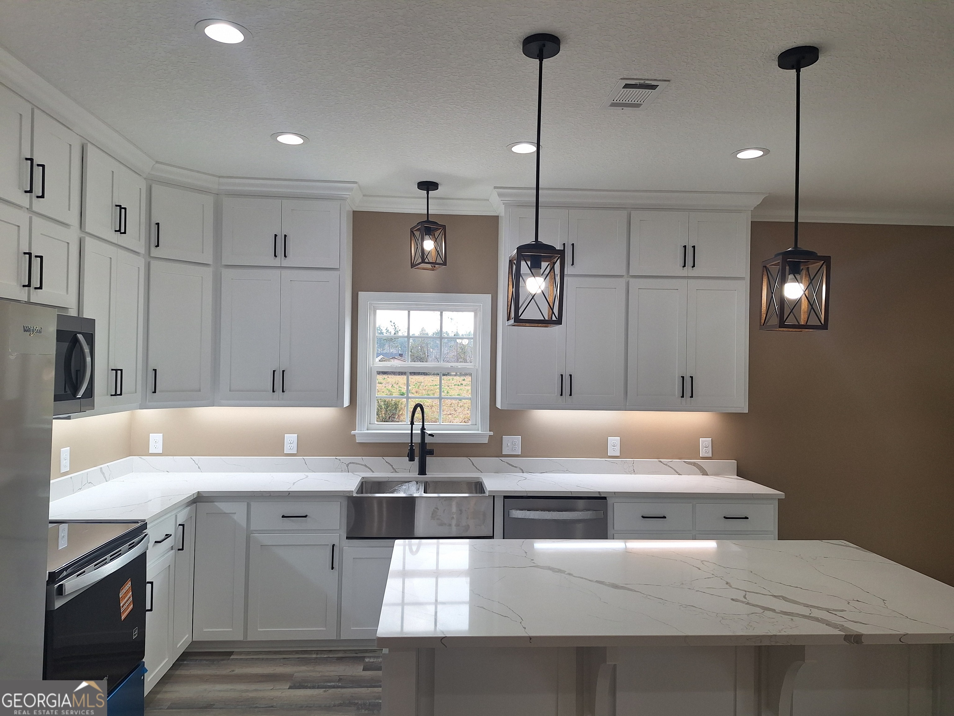 155 Peach Lane Baxley, GA 31513 - Photo 2 of 19 a kitchen with kitchen island granite countertop a sink a counter space and stainless steel appliances