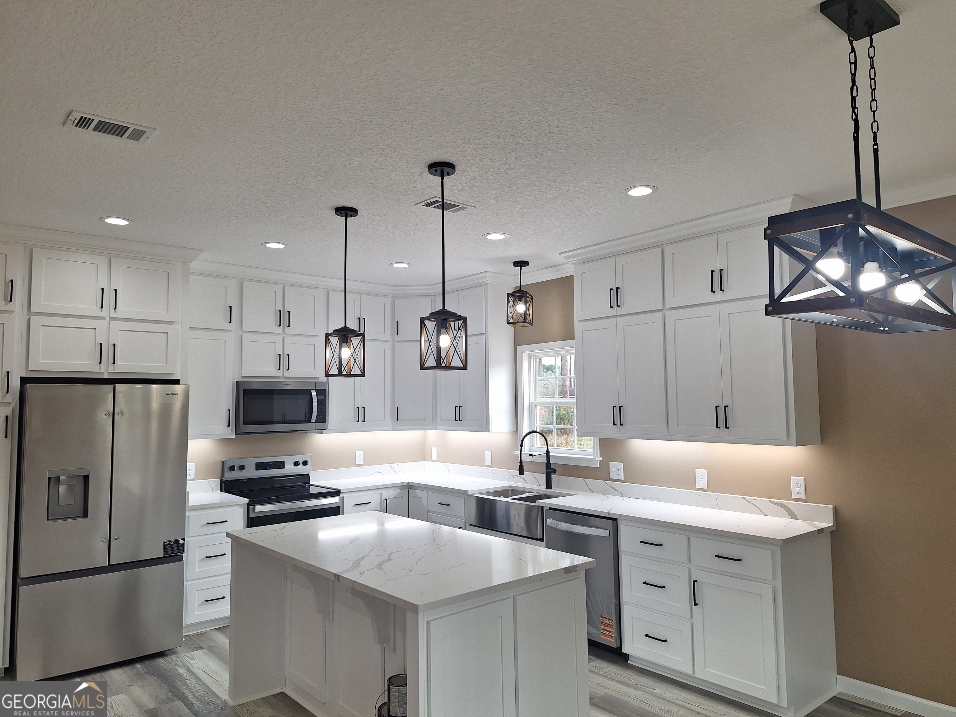 155 Peach Lane Baxley, GA 31513 - Photo 3 of 19 a kitchen with white cabinets and stainless steel appliances