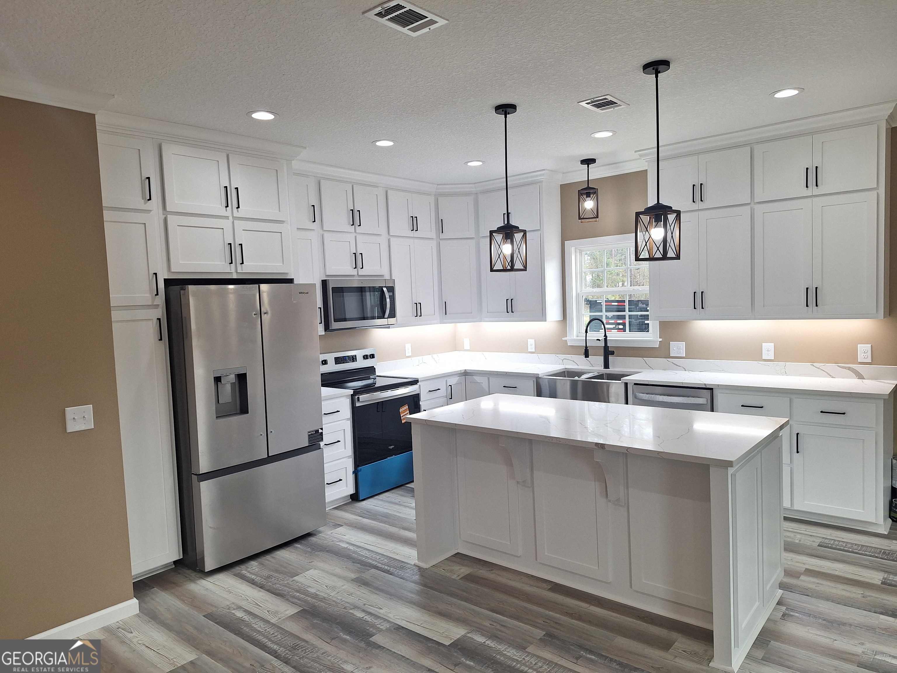 155 Peach Lane Baxley, GA 31513 - Photo 6 of 19 a kitchen with kitchen island a sink stainless steel appliances and cabinets