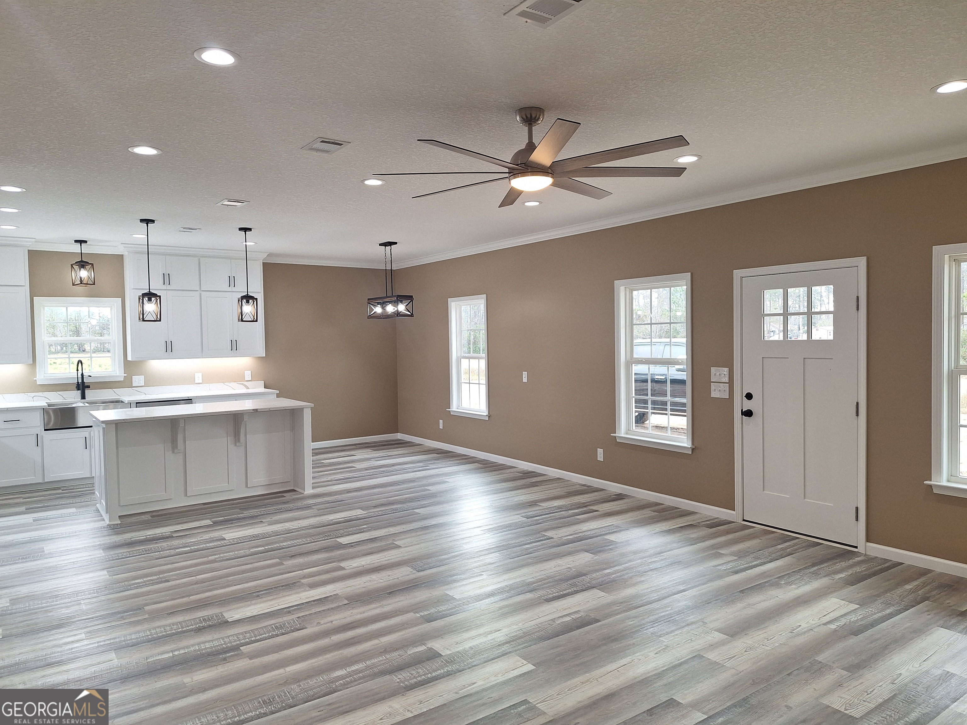 155 Peach Lane Baxley, GA 31513 - Photo 7 of 19 a view of kitchen and window with wooden floor