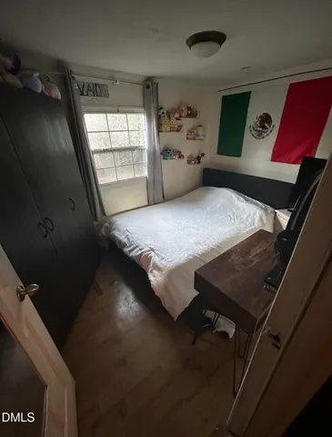 a bedroom with bed and window