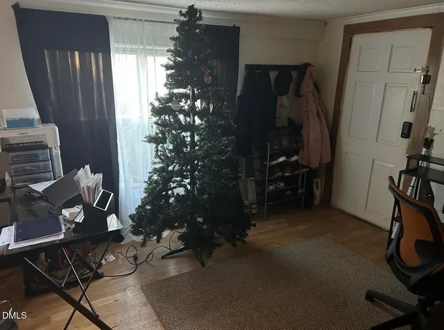 a room with wooden floor and a window