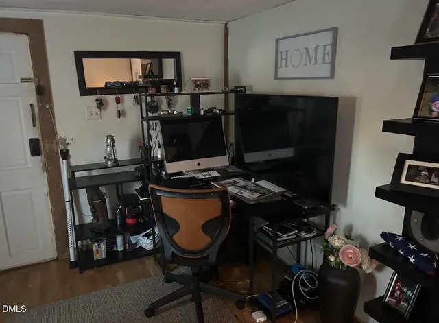 a view of a workspace with furniture and a flat screen tv