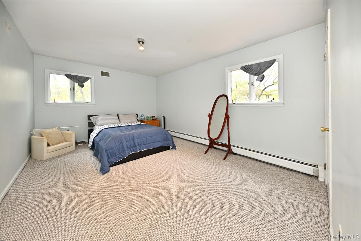 19 Sterling Road Spring Valley, NY 10977 - Photo 15 of 20 a bedroom with a bed a couch and a window
