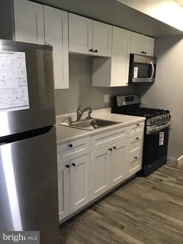 a kitchen with stainless steel appliances a refrigerator sink and stove