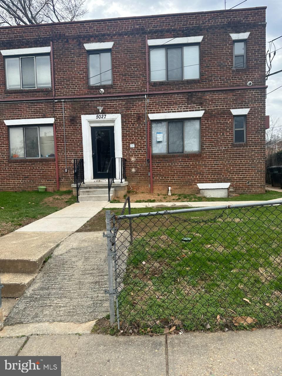 5027 H Street Southeast, Unit 3 Washington, DC 20019 - Photo 4 of 4 a front view of a house with a yard and garage