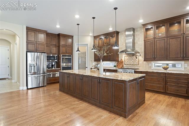 778 Cumberland Road Larkspur, CO 80118 - Photo 7 of 31 Appliances include two ovens plus warming drawer, fridge/freezer, dishwasher, and microwave