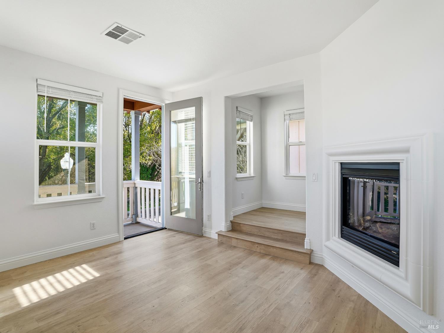 4424 Streamside Drive Santa Rosa, CA 95409 - Photo 9 of 55 a view of an empty room with wooden floor and a window
