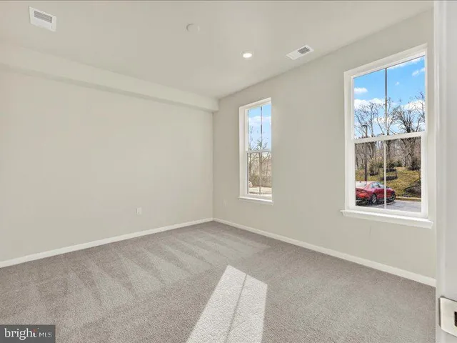 a view of an empty room and a window
