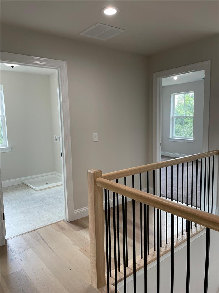 5043 Chapmans Road Orefield, PA 18069 - Photo 26 of 30 Clean lines define this bright hallway with rich hardwood flooring and a contemporary staircase.