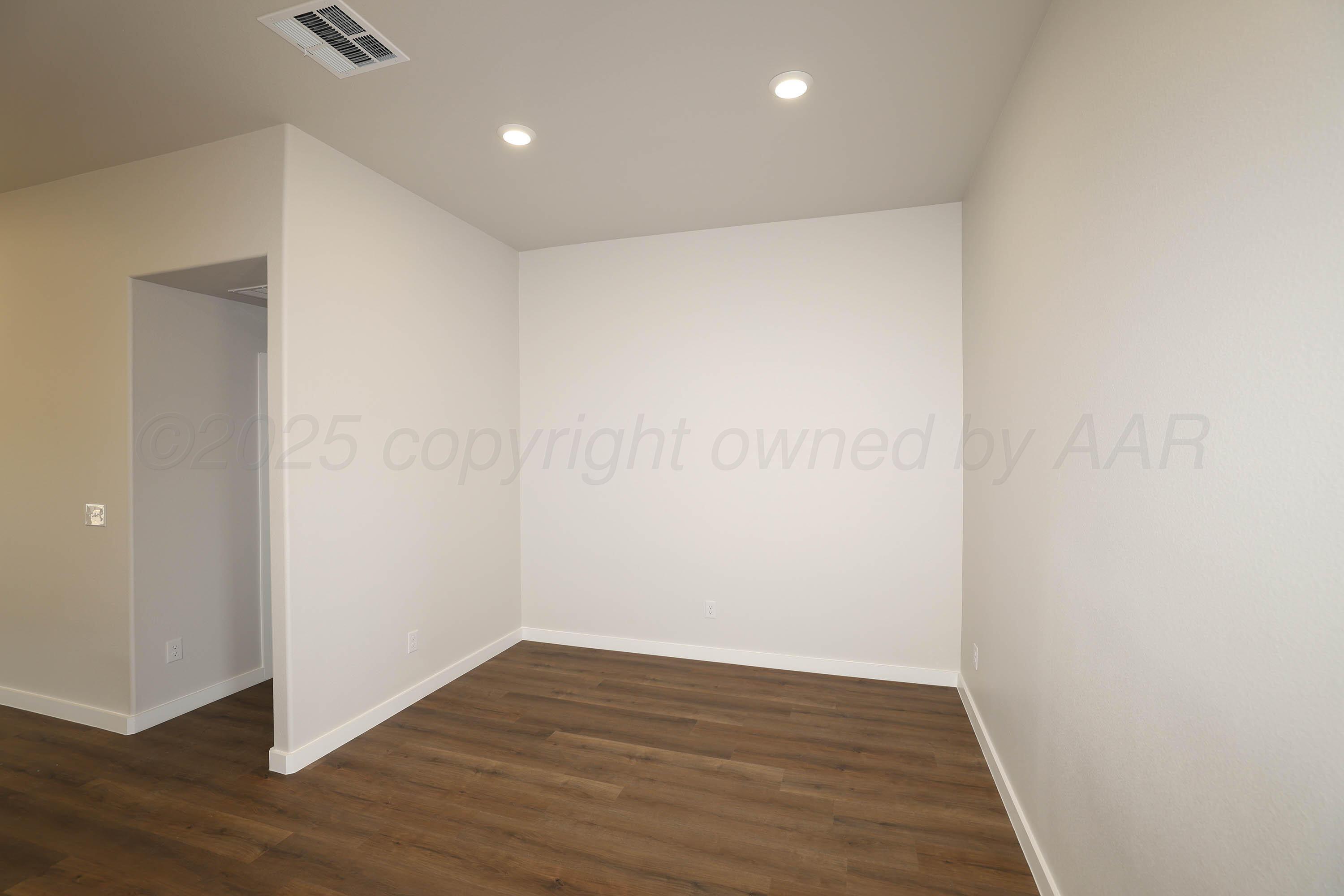 3003 Swenson Street Amarillo, TX 79124 - Photo 11 of 23 a view of an empty room with wooden floor
