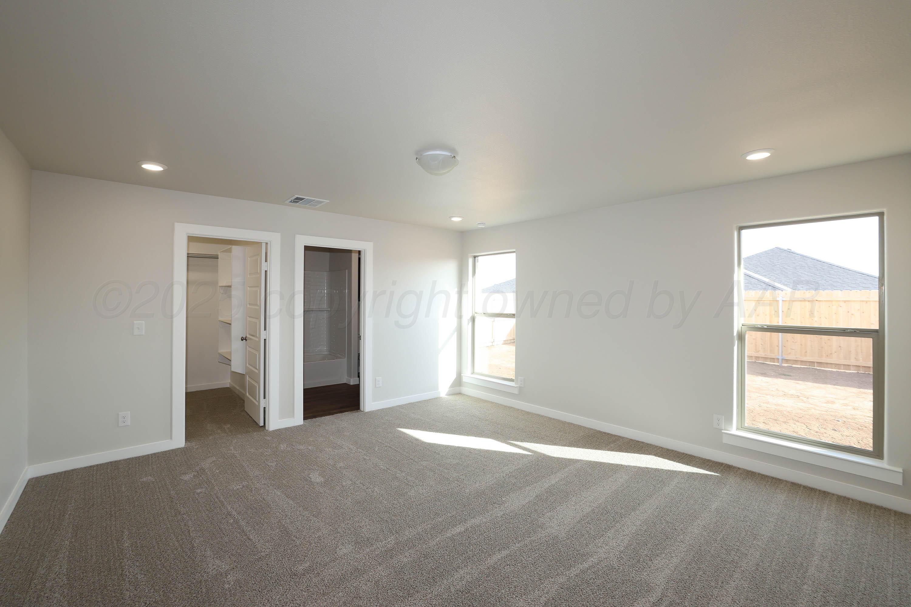 3003 Swenson Street Amarillo, TX 79124 - Photo 12 of 23 a view of a big room with windows and chandelier fan