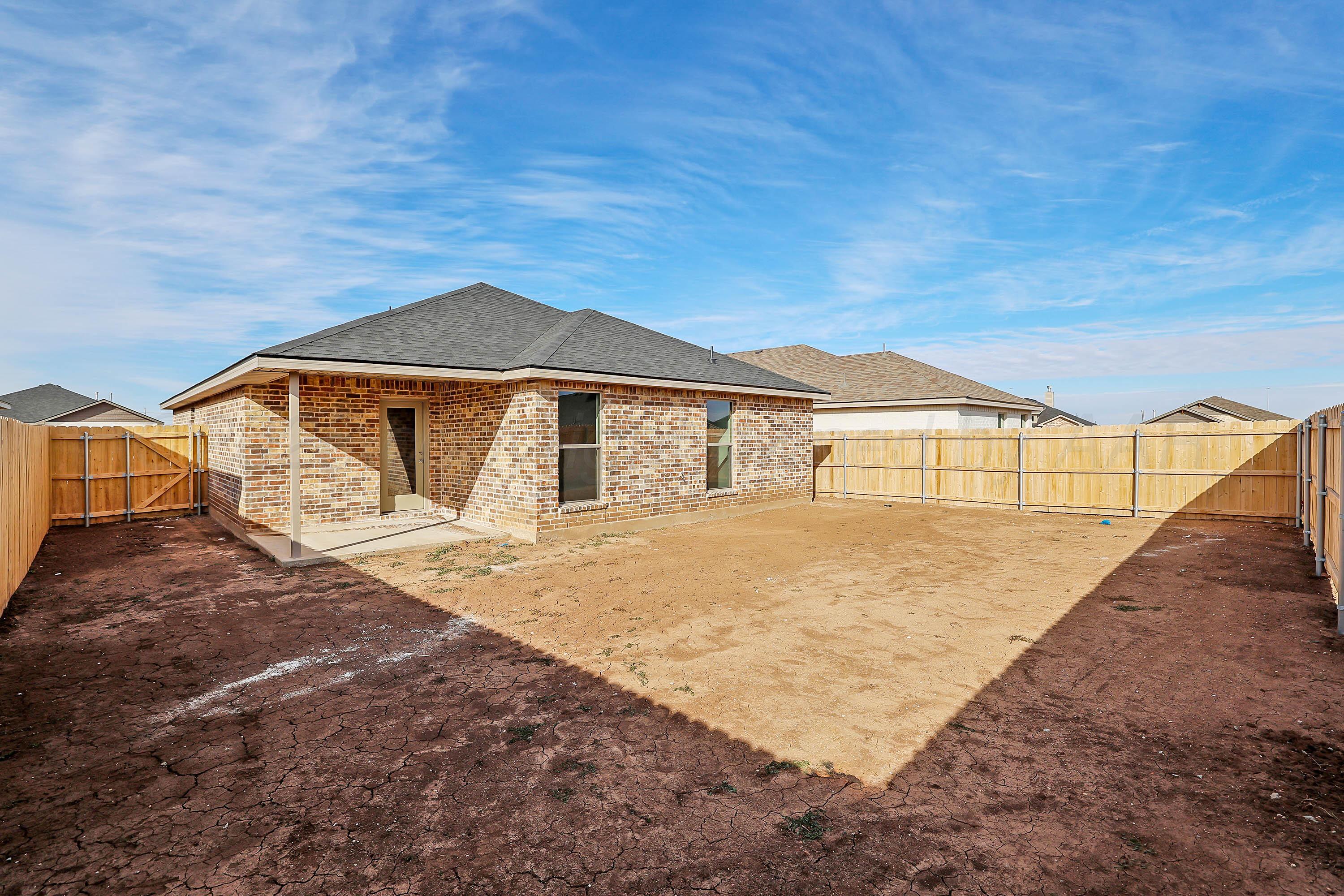 3003 Swenson Street Amarillo, TX 79124 - Photo 3 of 23 a front view of a house with a yard