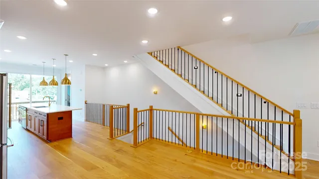 a view of front door with hallway and a kitchen
