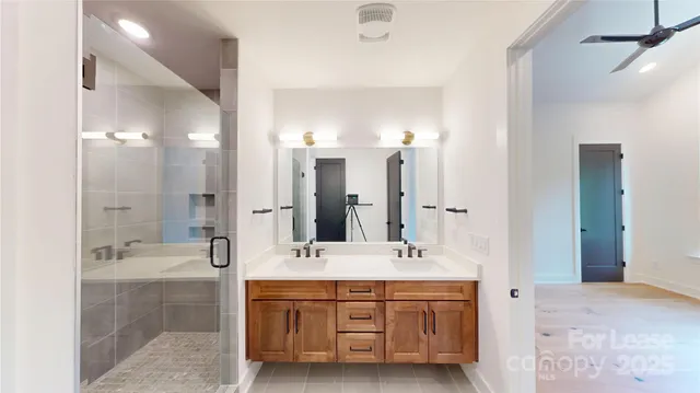 a bathroom with a double vanity sink mirror double and shower
