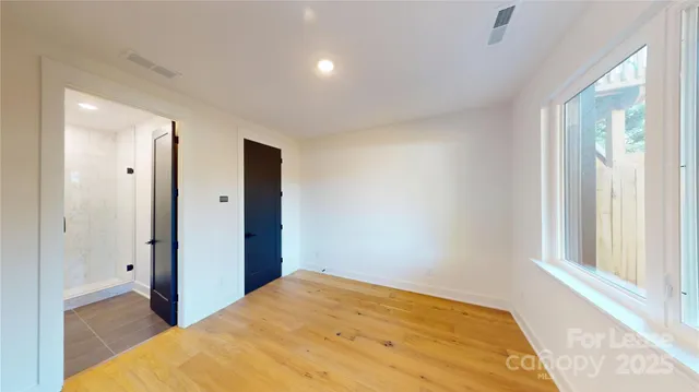 a bathroom with a bathtub shower sink mirror and toilet