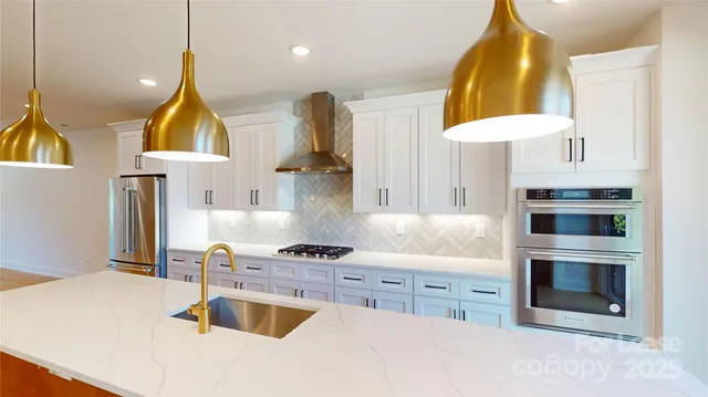 a kitchen with kitchen island granite countertop a stove a sink and a microwave