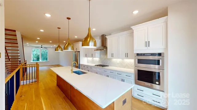 a kitchen with a stove a sink and a refrigerator