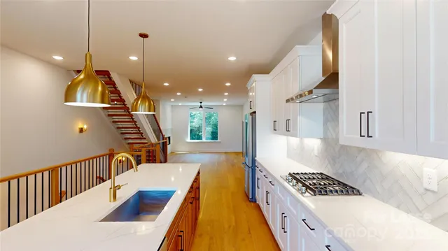 a very nice looking room with a large window and stainless steel appliances