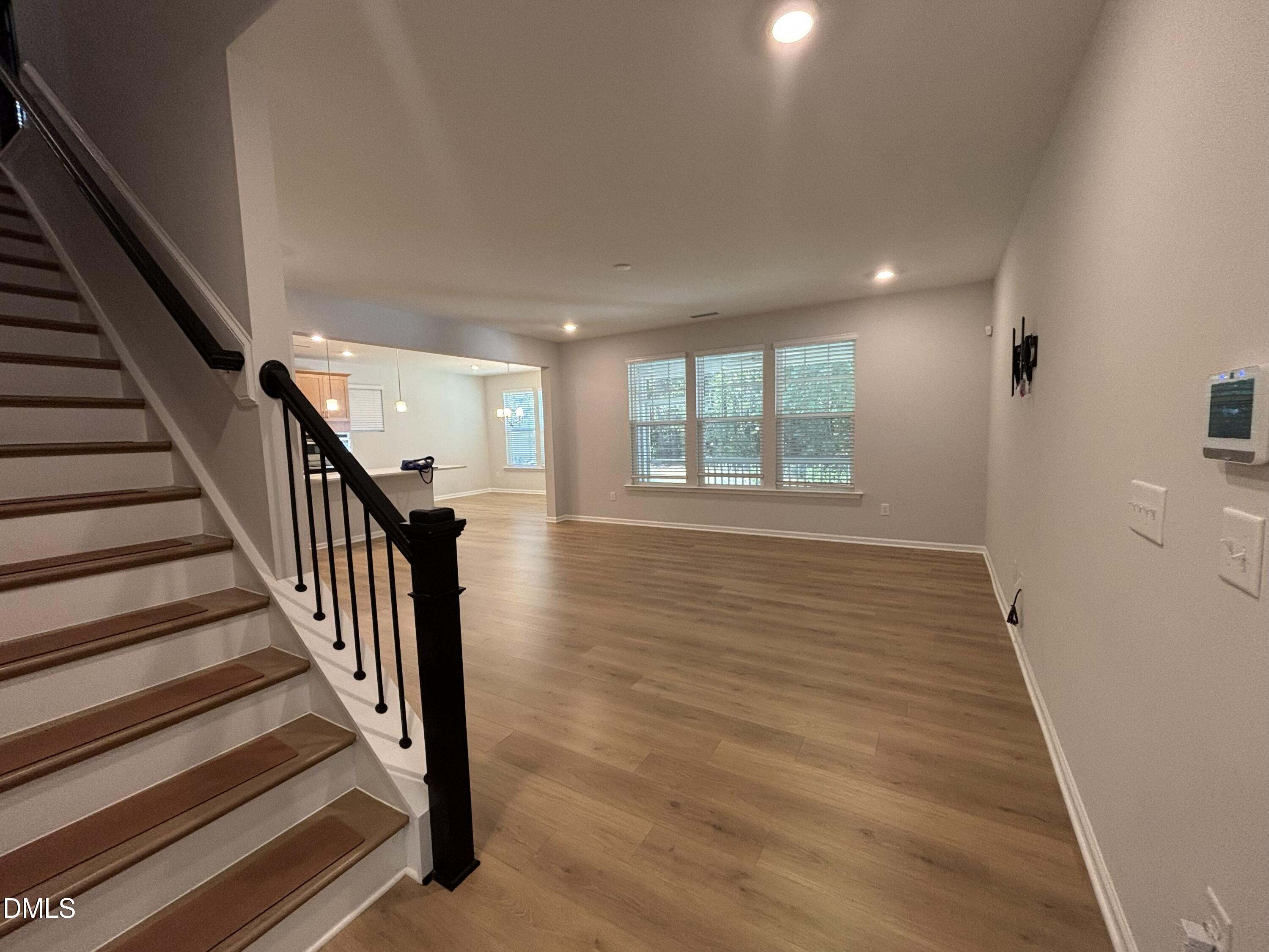 2105 Goudy Drive Raleigh, NC 27615 - Photo 11 of 41 an empty room with wooden floor and windows
