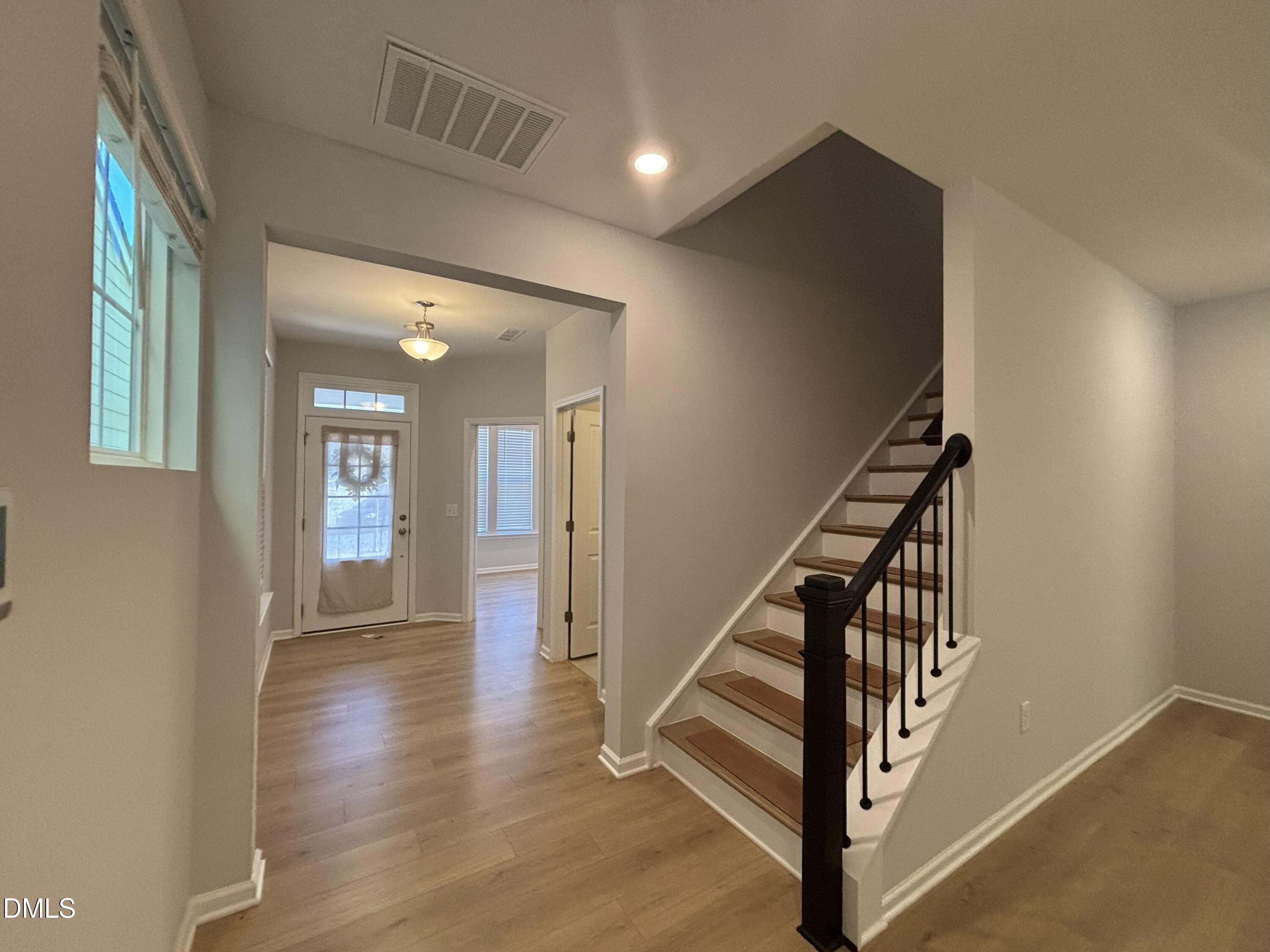 2105 Goudy Drive Raleigh, NC 27615 - Photo 12 of 41 a view of a hallway with wooden floor and staircase