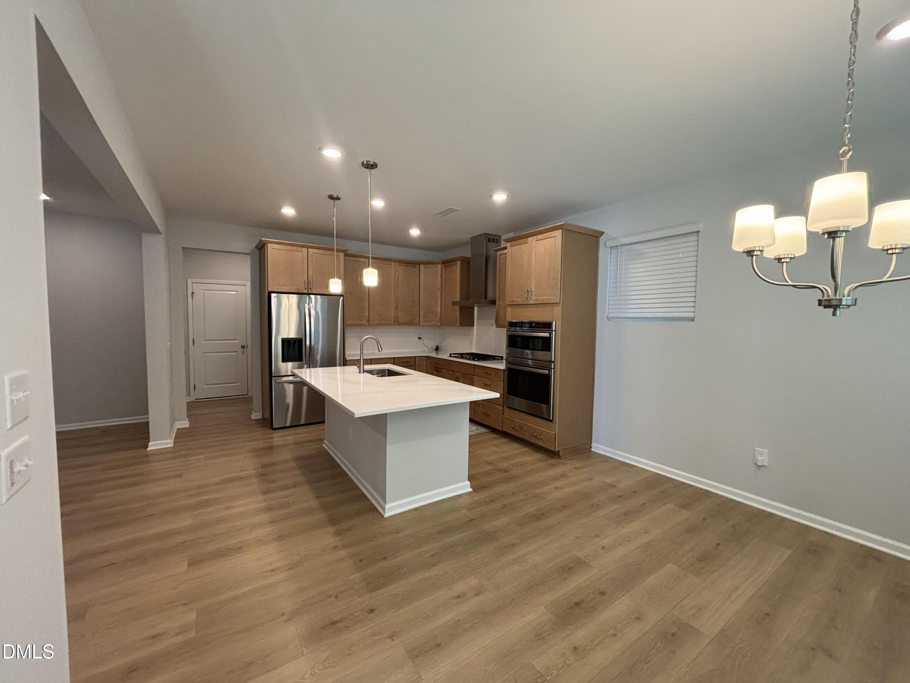 2105 Goudy Drive Raleigh, NC 27615 - Photo 15 of 41 a view of kitchen with refrigerator microwave and wooden floor