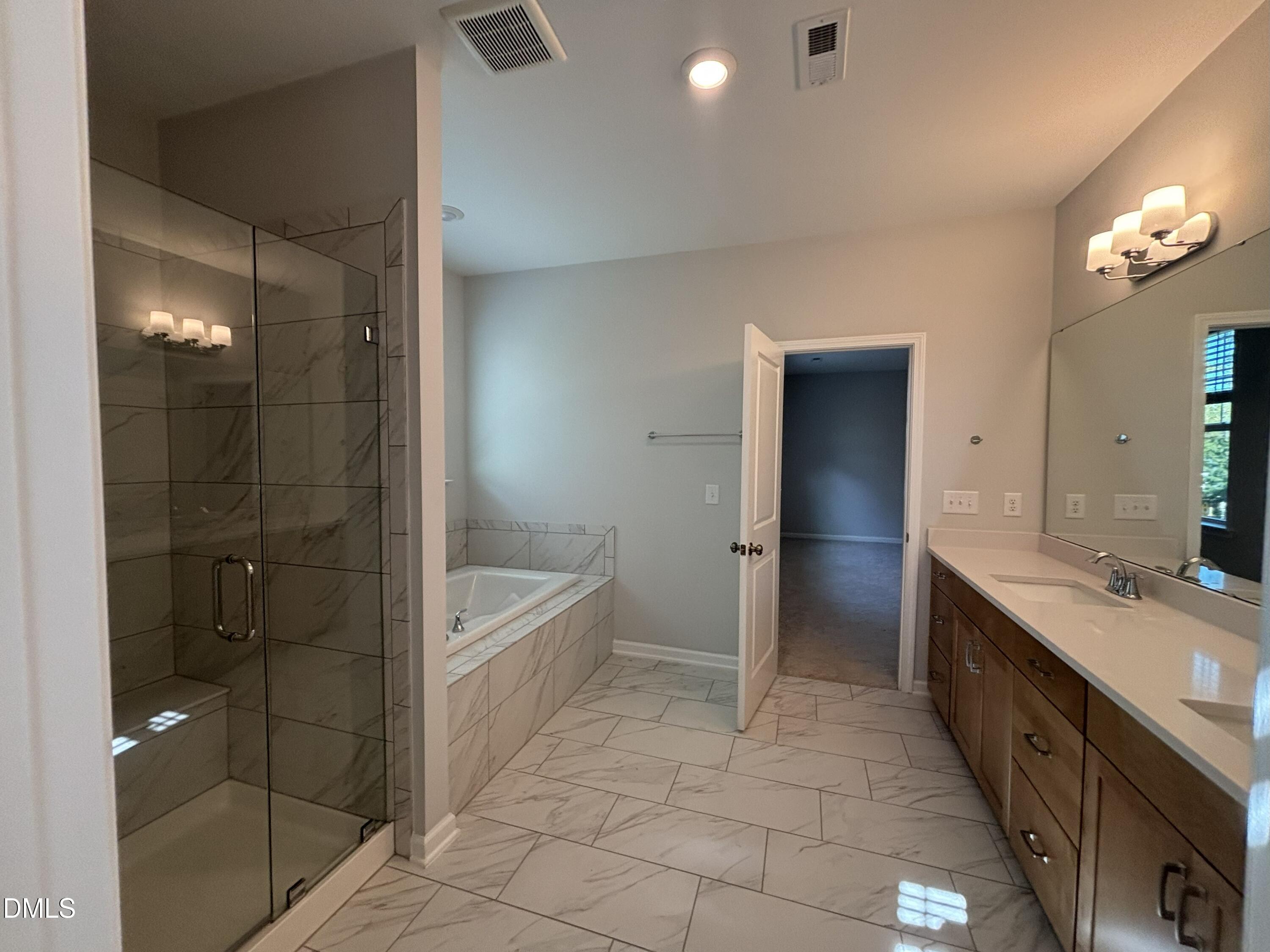 2105 Goudy Drive Raleigh, NC 27615 - Photo 29 of 41 a bathroom with a double vanity sink a toilet and shower