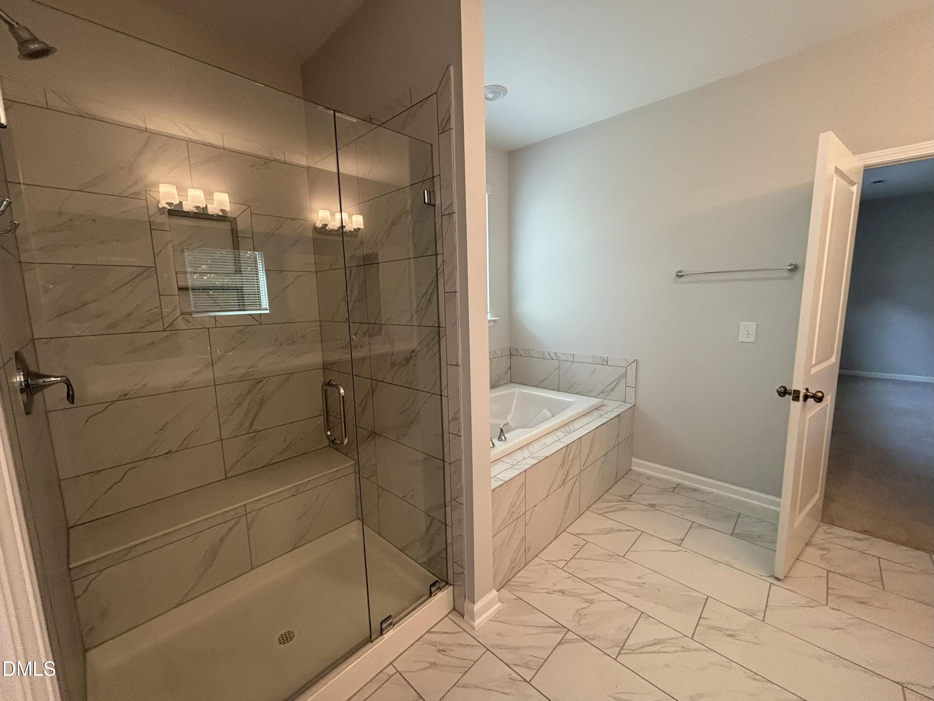 2105 Goudy Drive Raleigh, NC 27615 - Photo 3 of 41 a bathroom with a bathtub and a shower