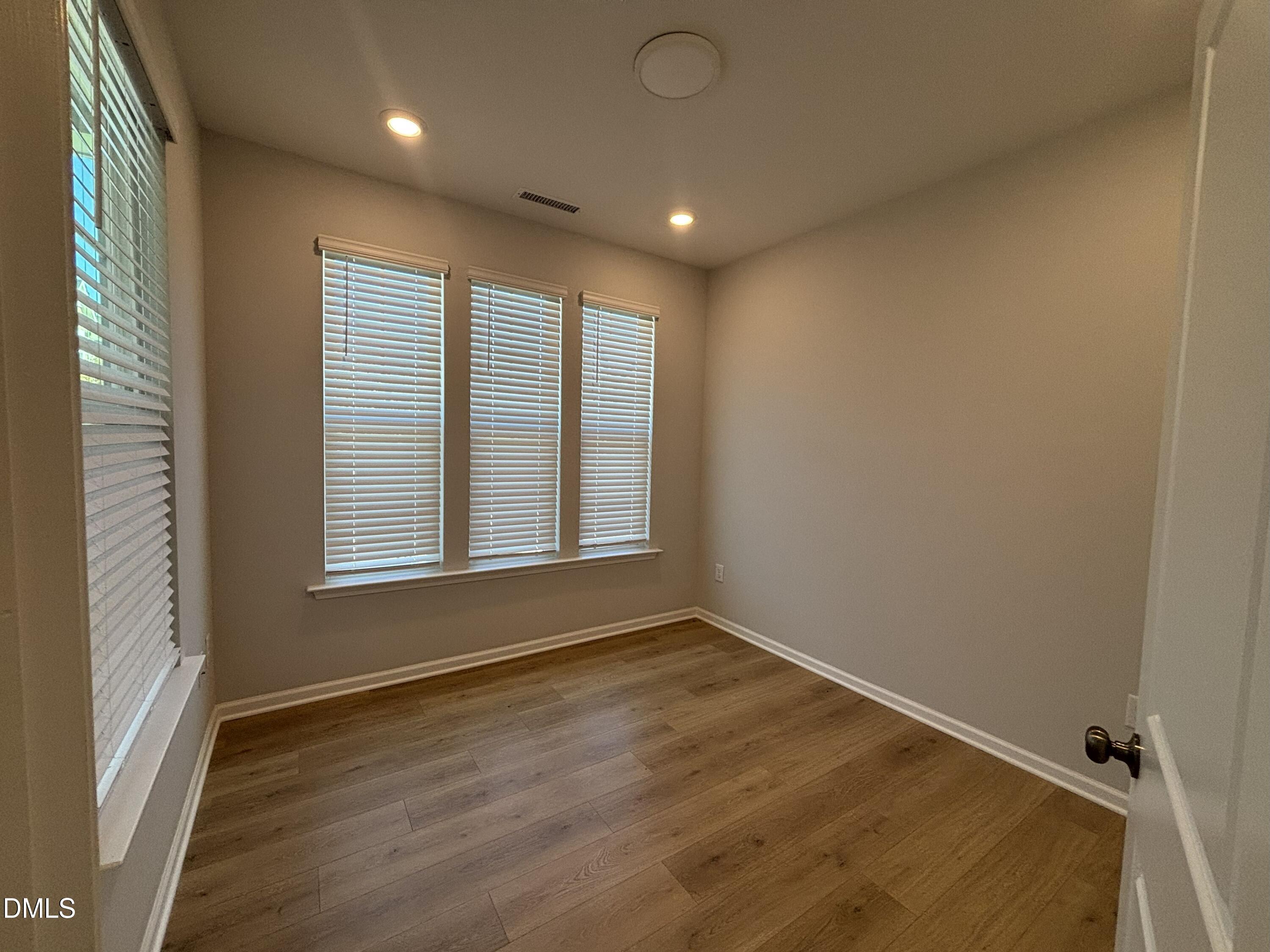 2105 Goudy Drive Raleigh, NC 27615 - Photo 8 of 41 a view of an empty room with wooden floor and a window