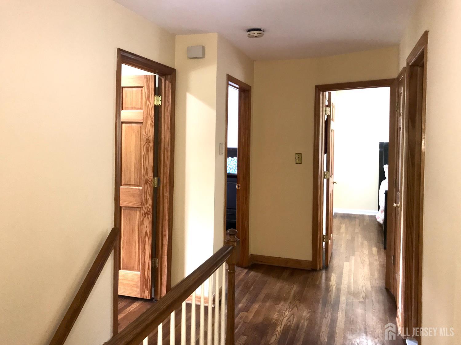 39 Taylor Road Monmouth Junction, NJ 08852 - Photo 20 of 36 a view of a hallway with wooden floor and stairs