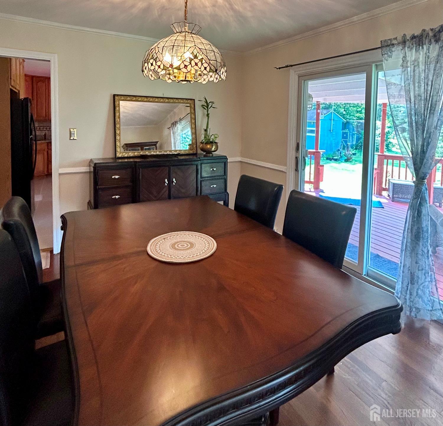 39 Taylor Road Monmouth Junction, NJ 08852 - Photo 8 of 36 a view of a dining room with furniture a chandelier windows and wooden floor