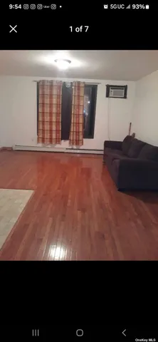 a view of an empty room and with kitchen