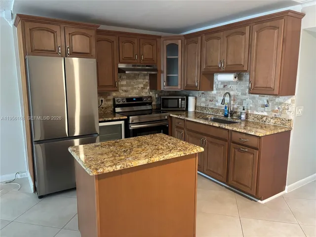 a kitchen with a sink stove and refrigerator